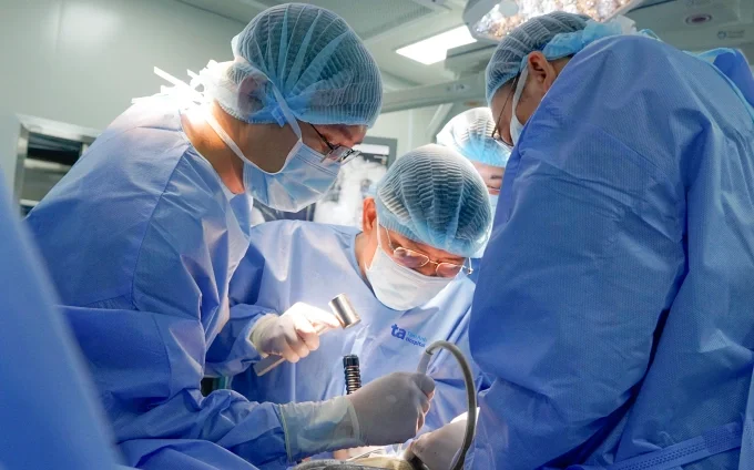 Bác sĩ Hiển (giữa) bóc tách khối bướu cho người bệnh. Ảnh: Bệnh viện Đa khoa Tâm Anh